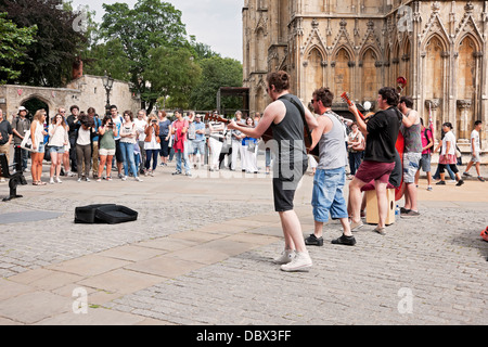 Group of young men street musicians performing busking in the city centre in summer York North Yorkshire England UK United Kingdom GB Great Britain Stock Photo