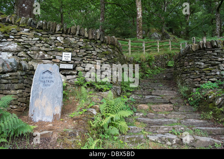 Slate sign by steps at start of Watkin path route through woodland to Mt Snowdon from Nant Gwynant valley, Snowdonia, North Wales, UK Stock Photo