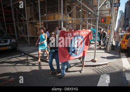 New York, New York. 04th Aug, 2013. Protesters in midtown Manhattan in New York demonstrate against the National Security Agency's surveillance of Americans' email and telephone conversations on Sunday, August 4, 2013. The protest was organized by a group called 'Restore the Fourth' referring to the Fourth Amendment of the Constitution which protects citizens against unreasonable searches by the government. Many citizens are opposed to the NSA activities and the events which took place around the country were called '1984 Day'. Credit:  Richard Levine/Alamy Live News Stock Photo