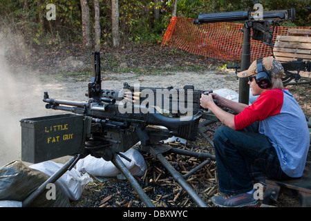 A young teenager firing a heavy machine gun at the Knob Creek Machine Gun Shoot. Stock Photo