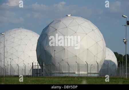 Bad Aibling, Germany. 06th Aug, 2013. Radomes (radar domes) are pictured behind a fence at the Bad Aibling Station near Bad Aibling, Germany, 06 August 2013. Bad Albing Station was a large spy station of US intelligence organization NSA (NAtional Security Agency). Photo: ANDREAS GEBERT/dpa/Alamy Live News Stock Photo