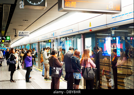 Unidentified people waiting for a subway train Stock Photo