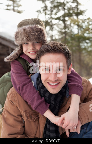 Close up portrait of happy father piggybacking son Stock Photo