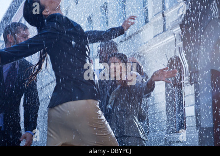 Business people dancing in rain Stock Photo