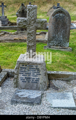 Stone cross in graveyard, Stone cross in cemetery,with family inscription on stone Stock Photo