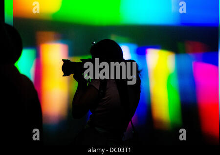 Berlin, Germany. 06th Aug, 2013. Visitors experiment with light at the Science Center Spectrum of the German Museum of Technology Foundation in Berlin, Germany, 06 August 2013. The Science Center Spectrum will reopen after extensive renovation works on 09 August 2013. Photo: MAURIZIO GAMBARINI/dpa/Alamy Live News Stock Photo