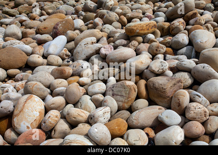 Background or semi abstract image of a pebble beach at Hayburn Wyke, between Scarborough and Whitby on the North Yorkshire North Sea Coast. Stock Photo