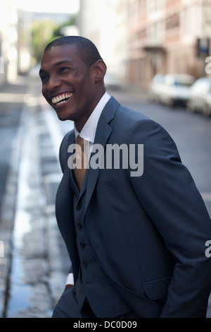 Happy businessman walking in street Stock Photo