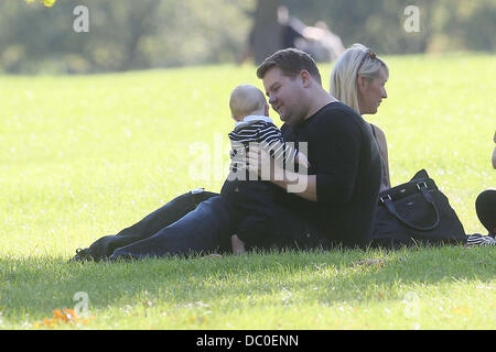 James Corden with wife Julia Carey and baby Max enjoying the sunshine at a park in Primrose Hill. London, England - 28.09.11 Stock Photo