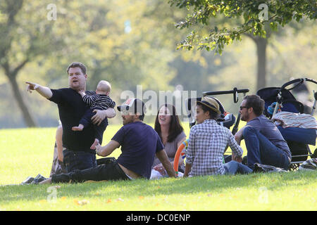 James Corden with baby Max enjoying the sunshine with friends at a park in Primrose Hill alongside Ruth Negga. London, England - 28.09.11 Stock Photo