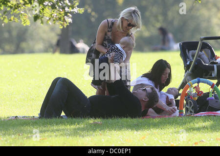 James Corden with wife Julia Carey and baby Max enjoying the sunshine at a park in Primrose Hill. London, England - 28.09.11 Stock Photo