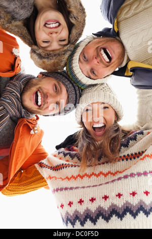 Low angle portrait of happy friends in huddle Stock Photo