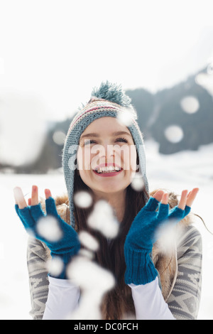 Happy woman watching snow fall Stock Photo