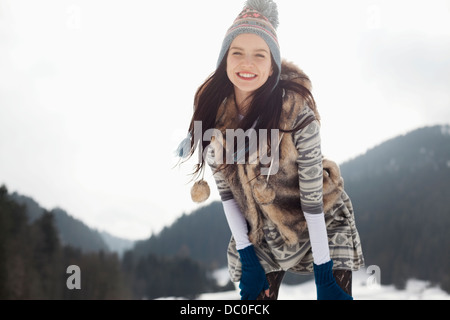 Portrait of happy woman in snow Stock Photo