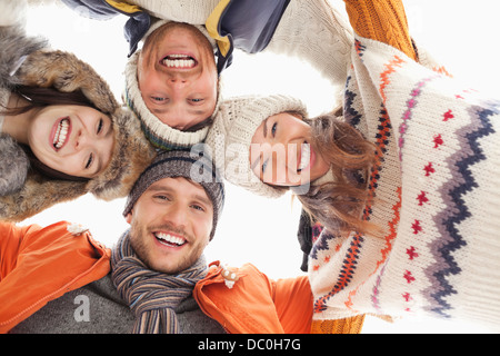 Low angle portrait of happy friends in huddle Stock Photo