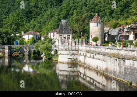 Picturesque scene of ancient wall to the River Dronne, a bridge over, and a tower. The commune of Brantôme, the Dordogne, south west France, Europe. Stock Photo