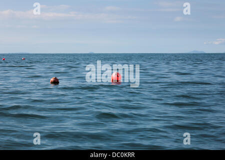 Aberystwyth, Wales, UK, 6 August 2013. The calm warm weather on Tuesday afternoon made ideal kayaking conditions out on the sea. This  view of the lobster pot buoys taken from the low angle of a touring kayak shows the beauty and tranquility of Cardigan Bay at it's best. Credit:  atgof.co/Alamy Live News Stock Photo