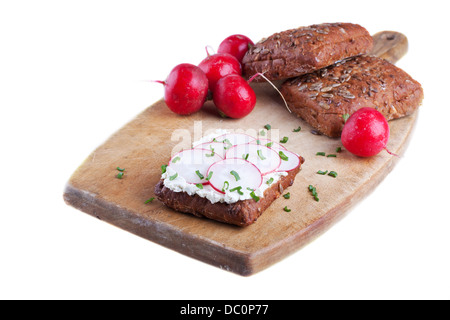 Radish and cream cheese on wholegrain bread garnished with chives Stock Photo