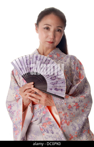 Japanese Lady Wearing a Pink and Lilac Patterned Kimono and Holding a Fan