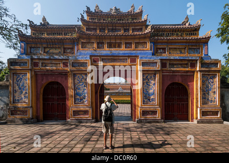 An tourist takes a picture of the Gateway of Dien Tho in the protected by UNESCO old imperial city of Hue, Vietnam, on January 11, 2008 Stock Photo
