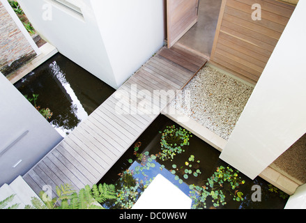 Footbridge over pool in modern house Stock Photo