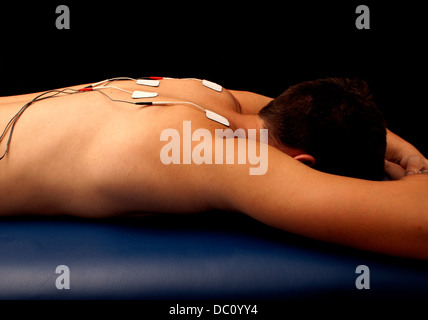 Man with TENS on his back Stock Photo