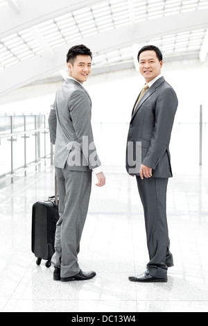 Confident business people in airport lobby Stock Photo