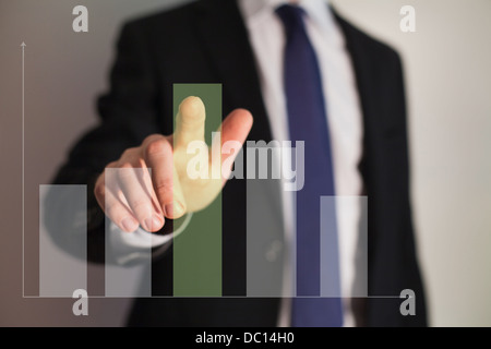 Businessman presenting a successful sustainable development on a bar chart Stock Photo