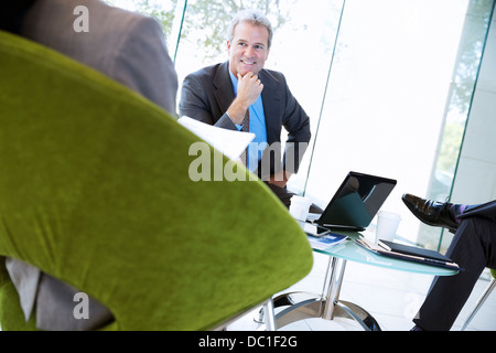Smiling businessman in meeting Stock Photo