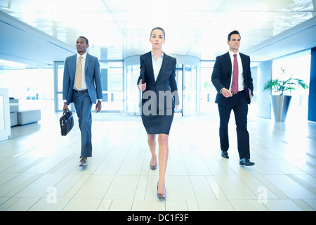 Determined business people walking in lobby Stock Photo