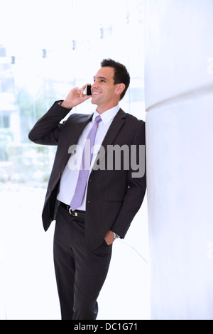 Smiling businessman talking on cell phone Stock Photo