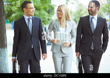 Image of friendly business team with two confident men and a lovely lady Stock Photo