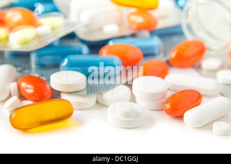 Assorted colorful pills and capsules on white background close up, horizontal, selective focus, medical concept. Stock Photo