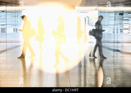 Business people walking in lobby Stock Photo