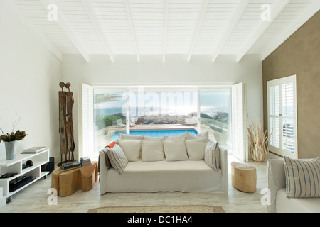 Living room overlooking swimming pool Stock Photo