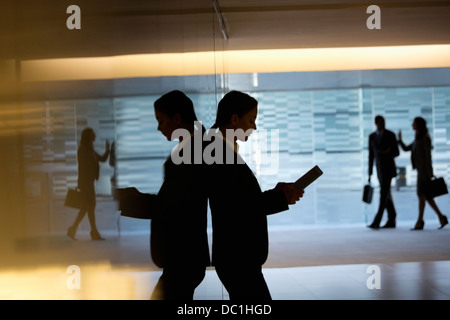 Businesswoman using digital tablet in lobby Stock Photo