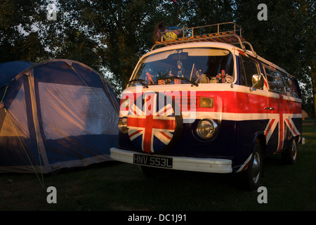 A VW camper van adorned with British Union Jacks colours, on a campsite at Reedham on the Norfolk Broads (more caption in Description). Stock Photo