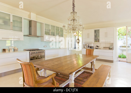 Chandelier over wooden table in kitchen