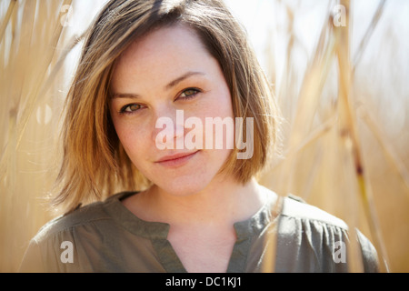 Close up portrait of young woman amongst reeds