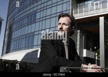 Mid adult businessman looking away in city Stock Photo