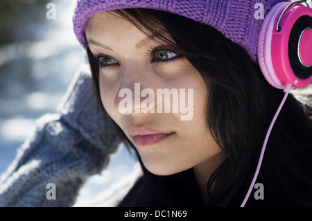 Close up portrait of young female listening to headphones Stock Photo