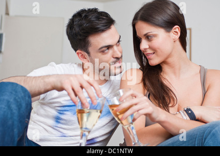 Romantic young couple sharing glass of wine Stock Photo