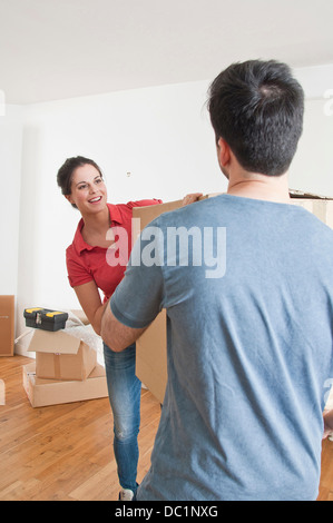 Young couple carrying cardboard box Stock Photo