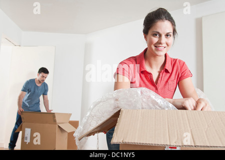 Young couple unpacking cardboard boxes Stock Photo