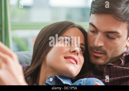 Romantic young couple lounging on sofa