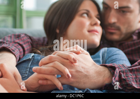 Close up of romantic young couple on sofa Stock Photo