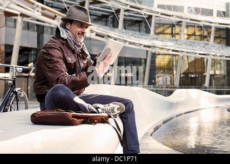 Mid adult man using digital tablet in city Stock Photo