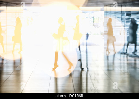 Business people walking in lobby Stock Photo