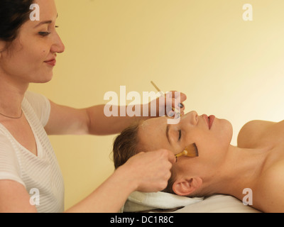 Young woman having face massage Stock Photo