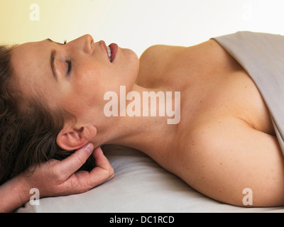 Young woman having her head massaged Stock Photo